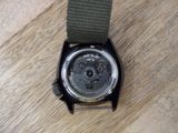 a watch that is sitting on a wooden table