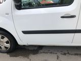 a small white car parked on the side of the road