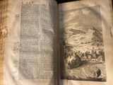 an open book with a picture of a mountain in the background