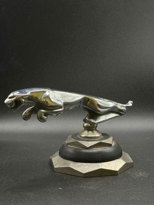a close up of a statue of a dog on a pedestal