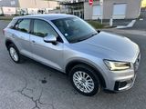 a silver audi suv parked in front of a building