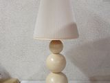 a lamp that is sitting on a table with a lamp shade on it