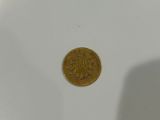 a close up of a coin sitting on top of a white plate