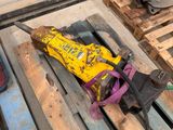a yellow object on a pallet next to a pair of shoes
