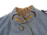a close up of a blue jacket with gold buttons on it