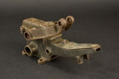an old engine that is sitting on a black surface