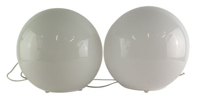 two white eggs sitting next to each other on a white surface