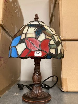 a lamp that is sitting on a table next to boxes