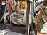 a machine that is sitting in a room with many pieces of wood