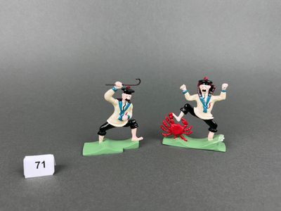 two figurines of a man with a sword and a woman with a sword