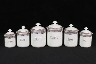 six white ceramic canisters with blue and white designs on them