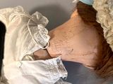 a doll with a white dress and a white hat