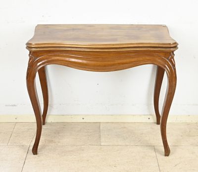 a wooden table with a drawer underneath it on a tiled floor