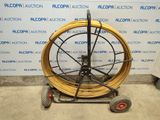an image of a large reel on a dolly in a room