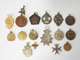 many different types of medals displayed on a white surface