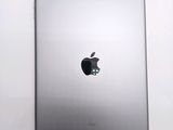 an apple ipad sitting on top of a white table next to a white wall