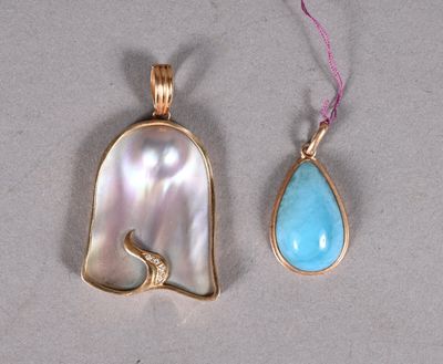 an image of two pendants with a tear shaped pendant and a tear shaped pendant with a tear shaped pendant