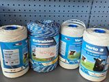 several spools of blue and white yarn are on a shelf