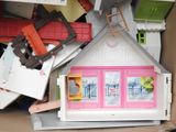 a cardboard box with a doll house inside of it