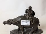 figurine of a man riding a horse with a dog on its back
