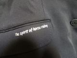 a close up of a black jacket with the words the spirit of work riding on it