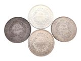 four different types of silver coins on a white background