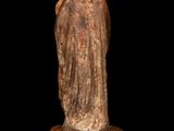 an old statue of a woman holding a child on a black background