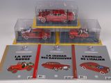 three books on the table with a red car in the middle