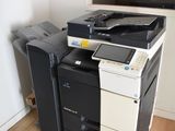 a black and white printer sitting on top of a wooden floor