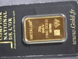 a gold bar in the package on the table