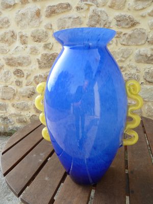a large blue vase sitting on a wooden table