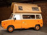 an orange van with a large box on top of it