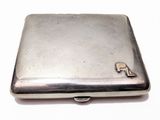 a small silver box with a letter p on it