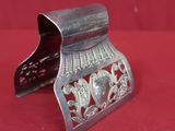 an old silver metal object on a red cloth