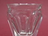 a small glass cup sitting on a red surface