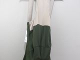 a green and white dress hanging on a hanger