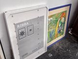 three framed art pieces on the floor next to each other