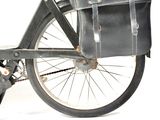 a black bicycle with a leather bag on the back of it