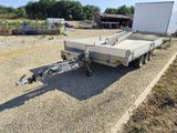 a trailer with a trailer attached to it parked in a lot