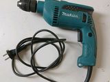 a cord that is connected to a drill on a table