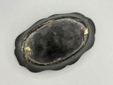 an image of a piece of black stone on a white surface