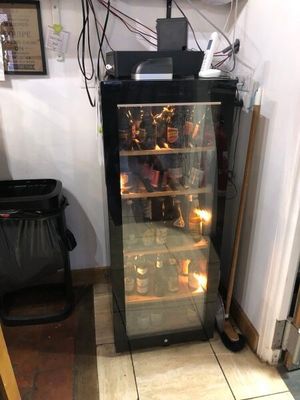 a small refrigerator with a lot of bottles in it