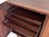 a close up of a wooden cabinet with drawers