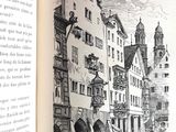 an open book with a drawing of a building on it
