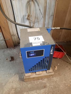 a blue machine that is sitting in a garage