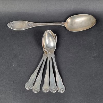 five spoons and two spoons on a black surface