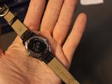 a person holding a smart watch in their hand
