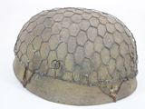 a helmet with a net covering it on a white surface