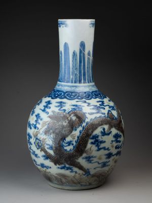 an image of a blue and white vase with a bird on it