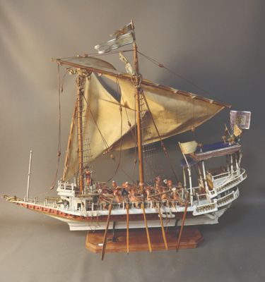 a model of a boat with a lot of people on it